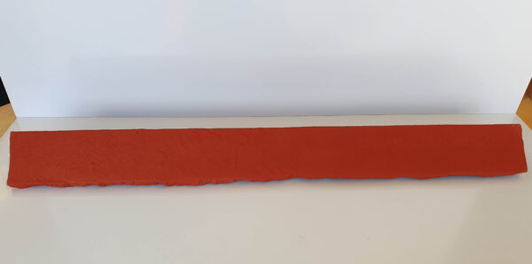 Red faux brick sill piece with a rough texture and natural edge